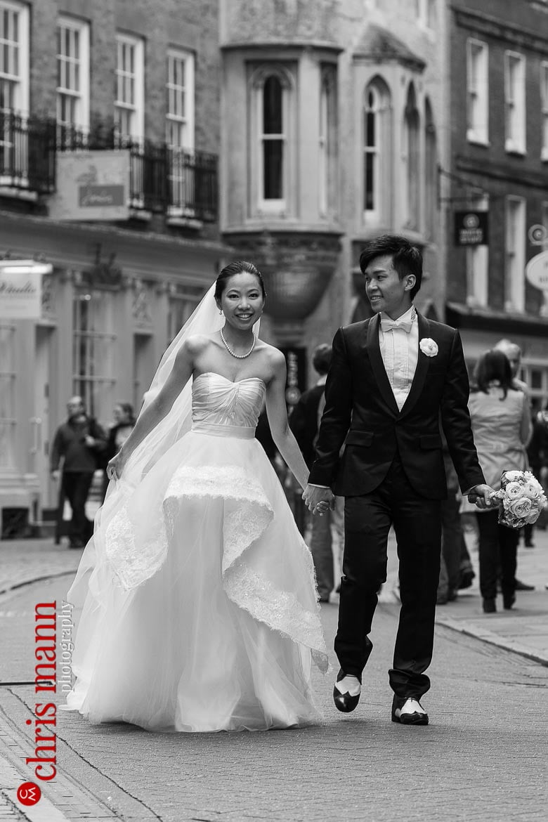 Cambridge pre-wedding shoot couple walking through streets