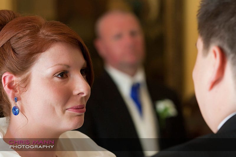 Kimberley & Richard at Bentley - bride and groom with father in background Kimberley & Richard at Bentley - bride and groom with father in background