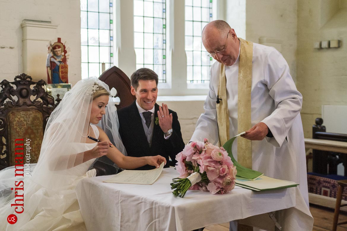 groom shows off wedding ring after wedding at St George's Church Campden Hil London 