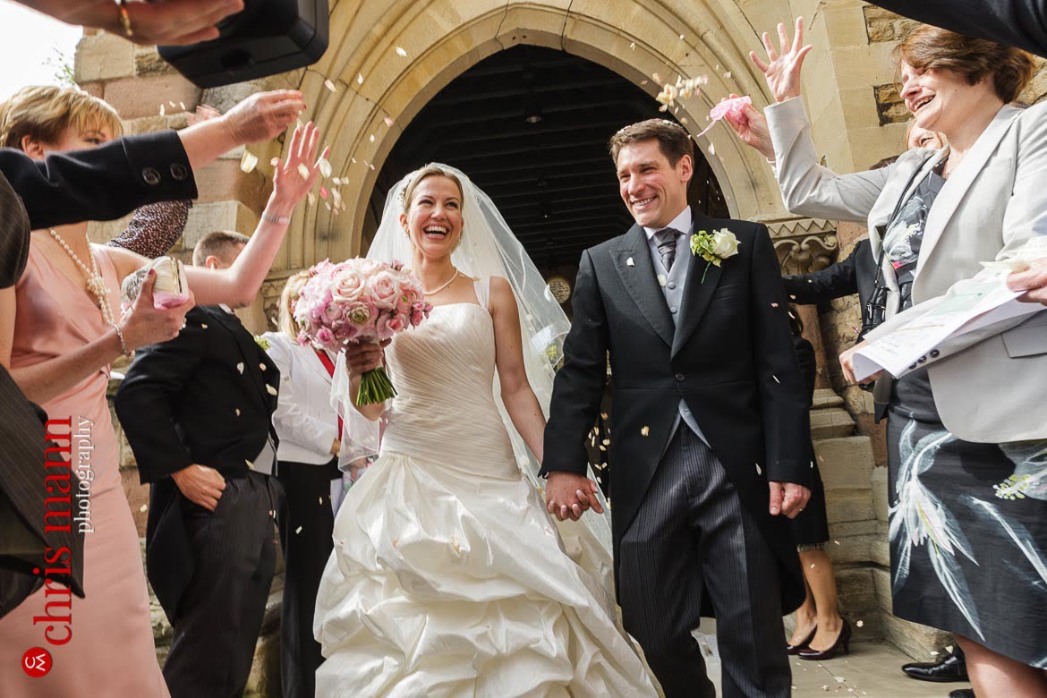 bride and groom leave St George's Church Campden Hil London amid confetti toss