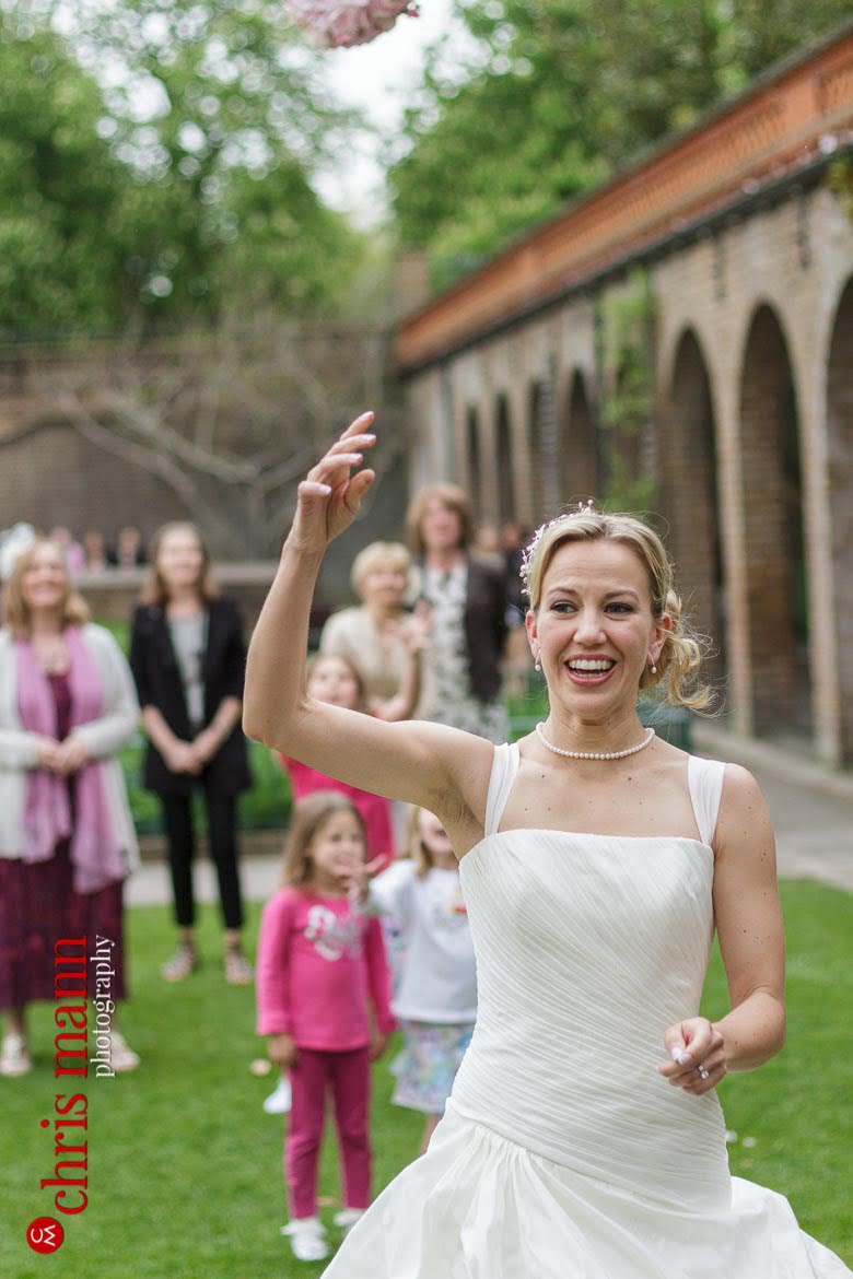 Orangery Holland Park Wedding bride tosses bouquet to guests