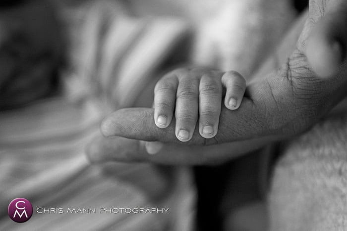 father holding his baby's hand