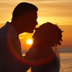 Destination wedding planning tips - Couple sunset silhouette