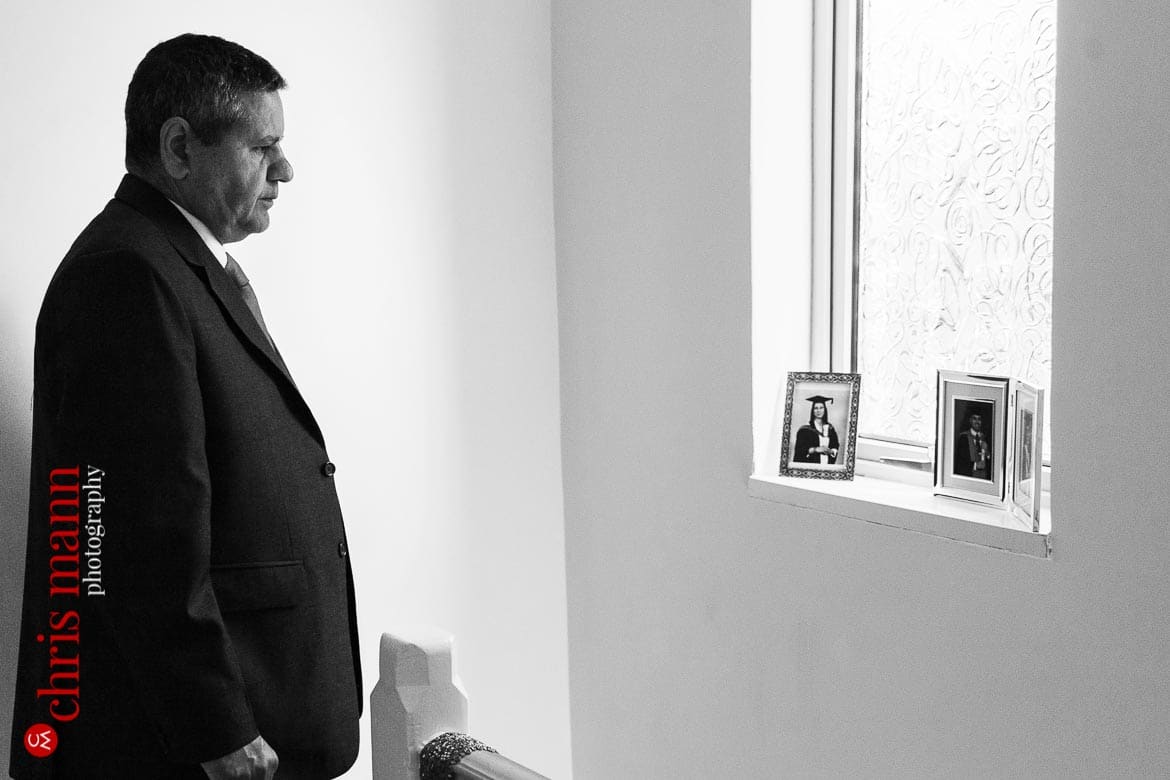 father of bride looks at photos of his children