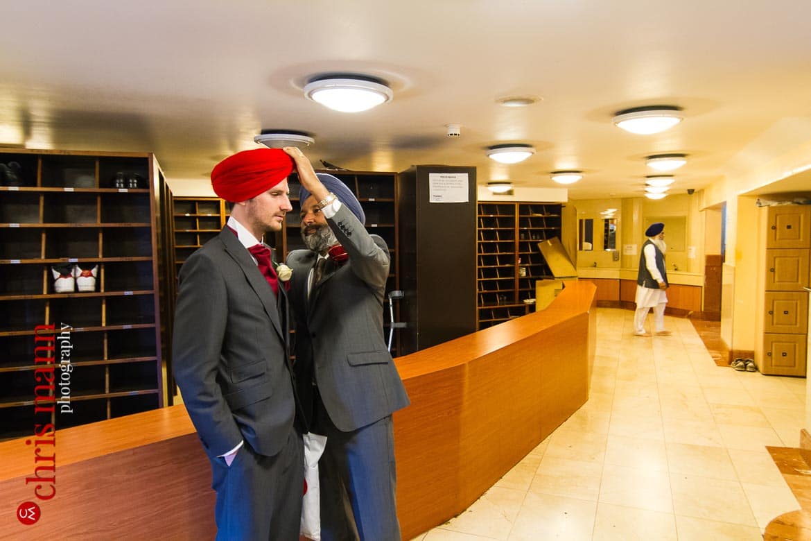 groom's turban is adjusted before Sikh wedding