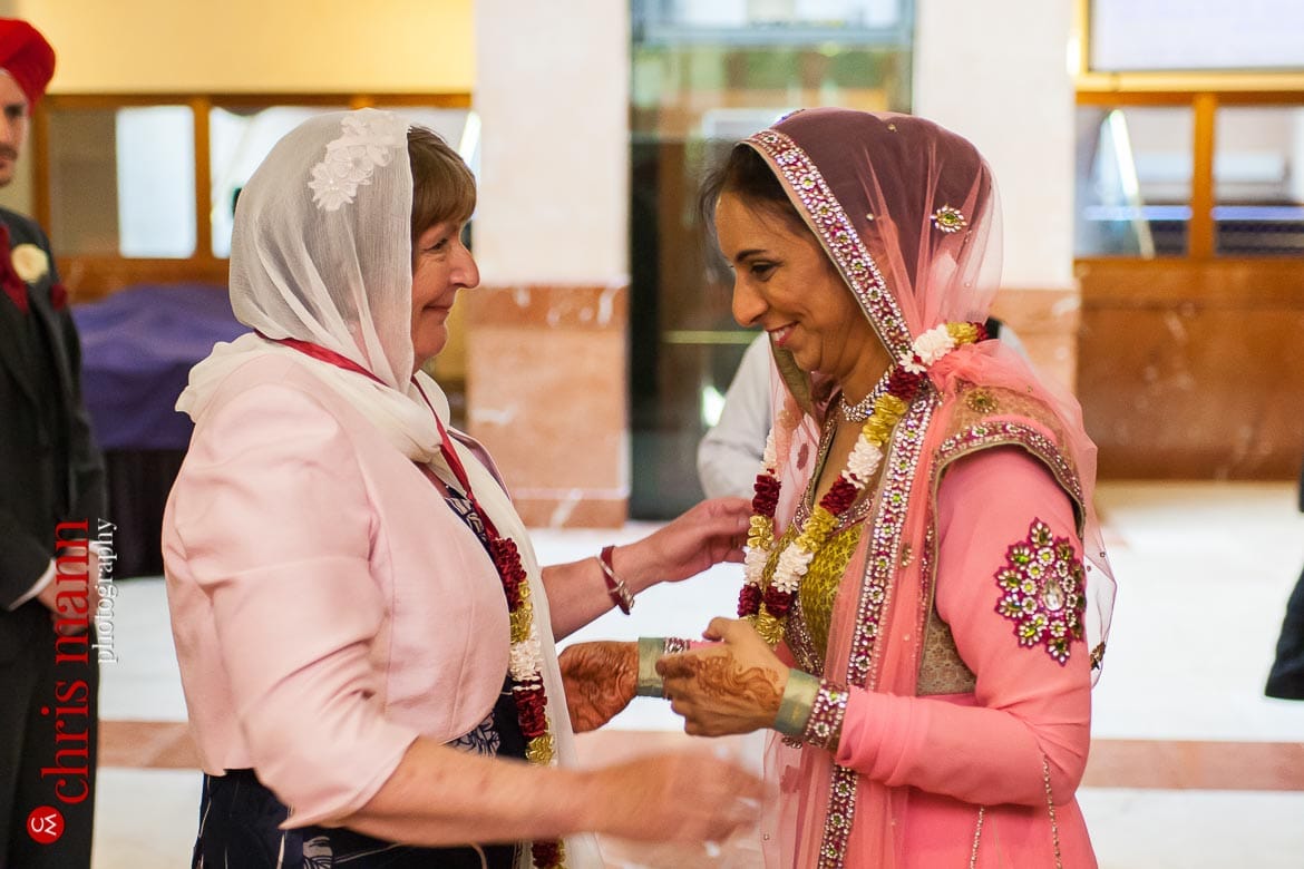mothers of bride and groom greet each other Sikh wedding