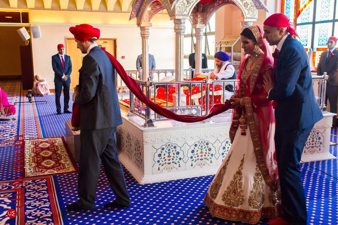 Bride and groom in procession at Sikh wedding ceremony