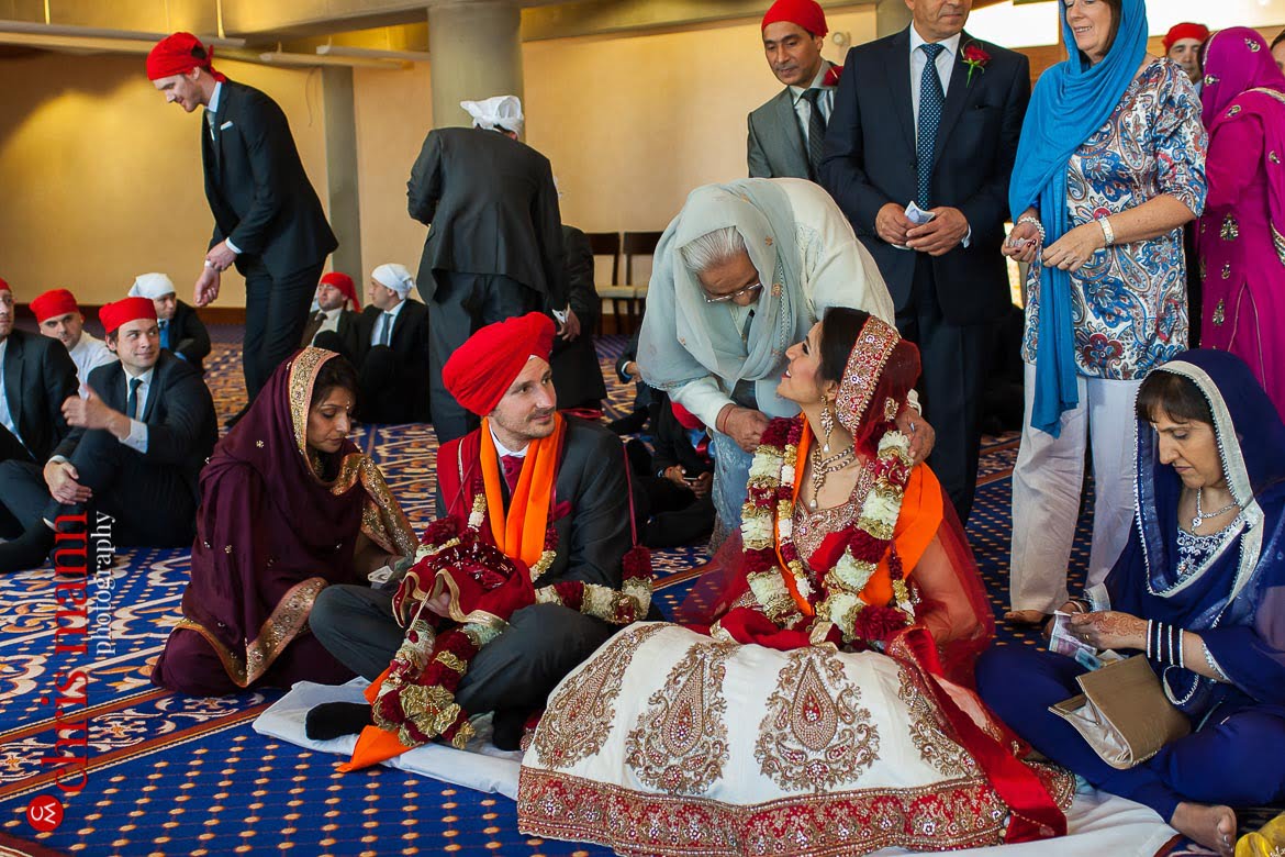 grandmother congratulates bride at Sikh wedding ceremony