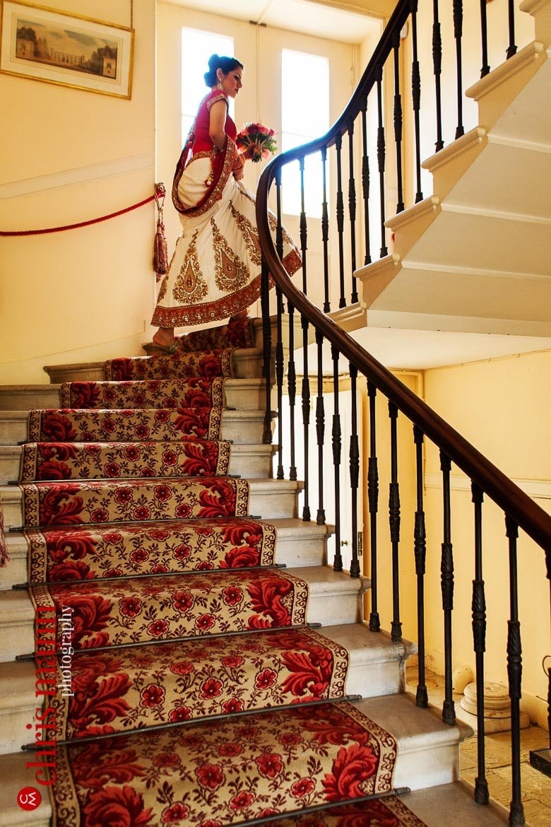 bride ascends staircase at Syon House London wedding