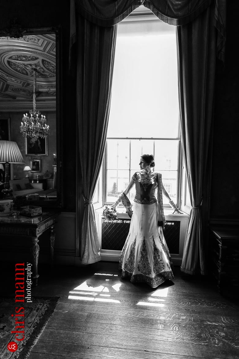 bride poses by window Syon House London wedding