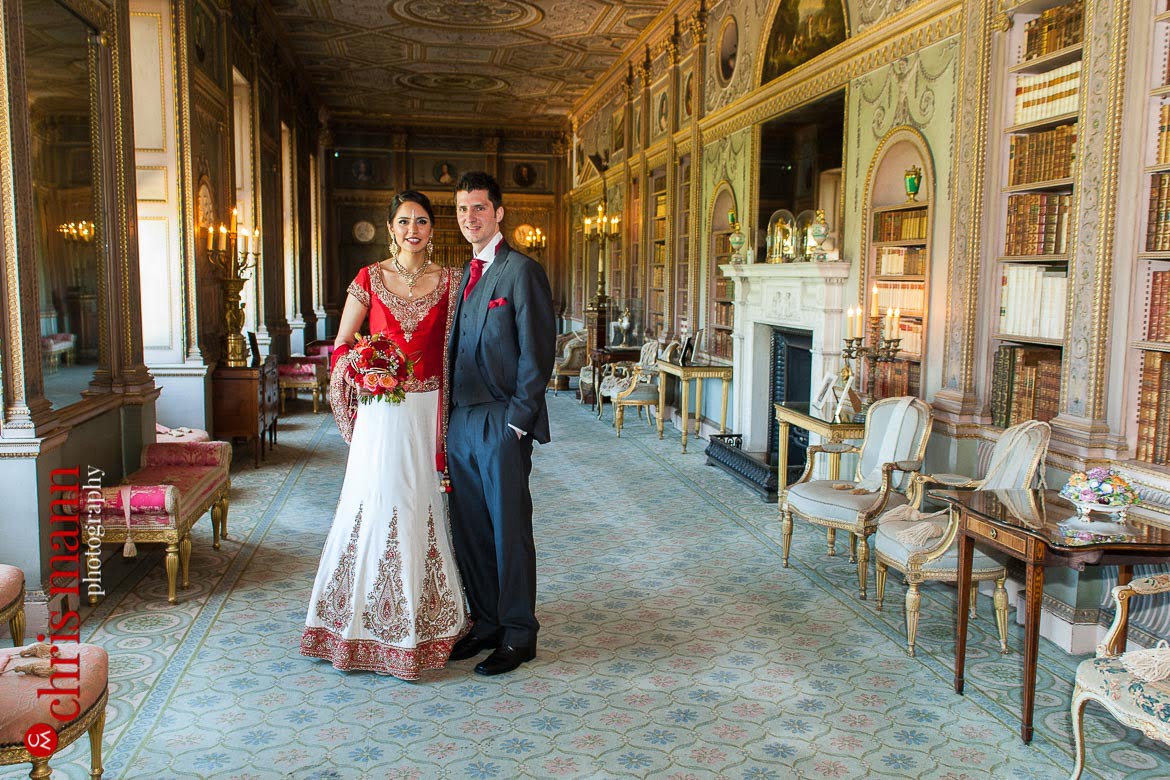 bride and groom pose in library at Syon House London