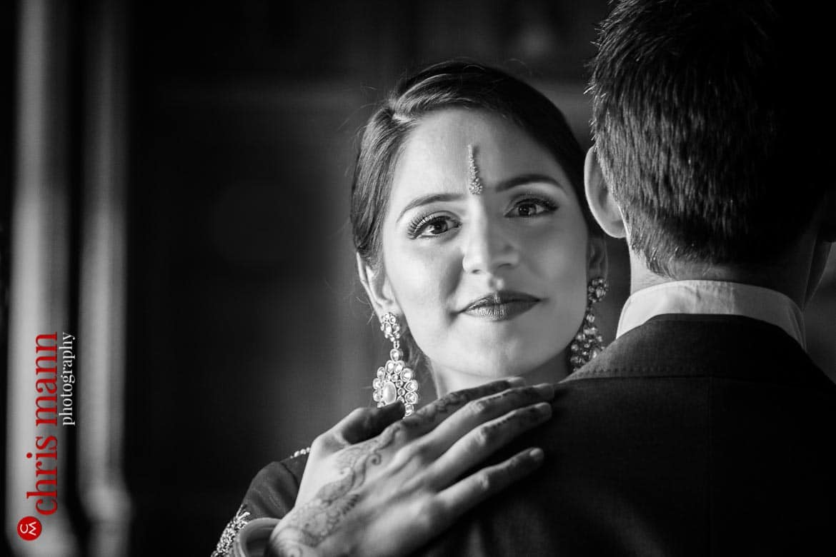 bride looks at camera over groom's shoulder wedding Syon Park London