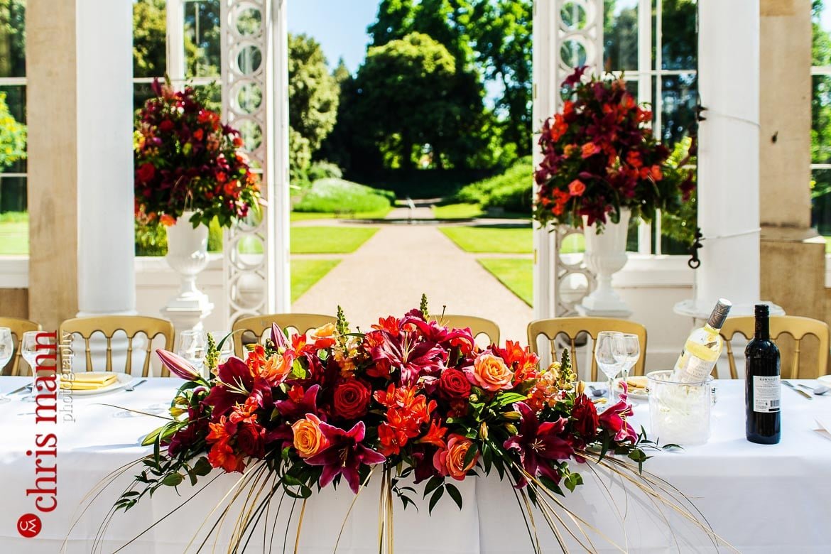 wedding reception flowers on top table conservatory Syon Park London