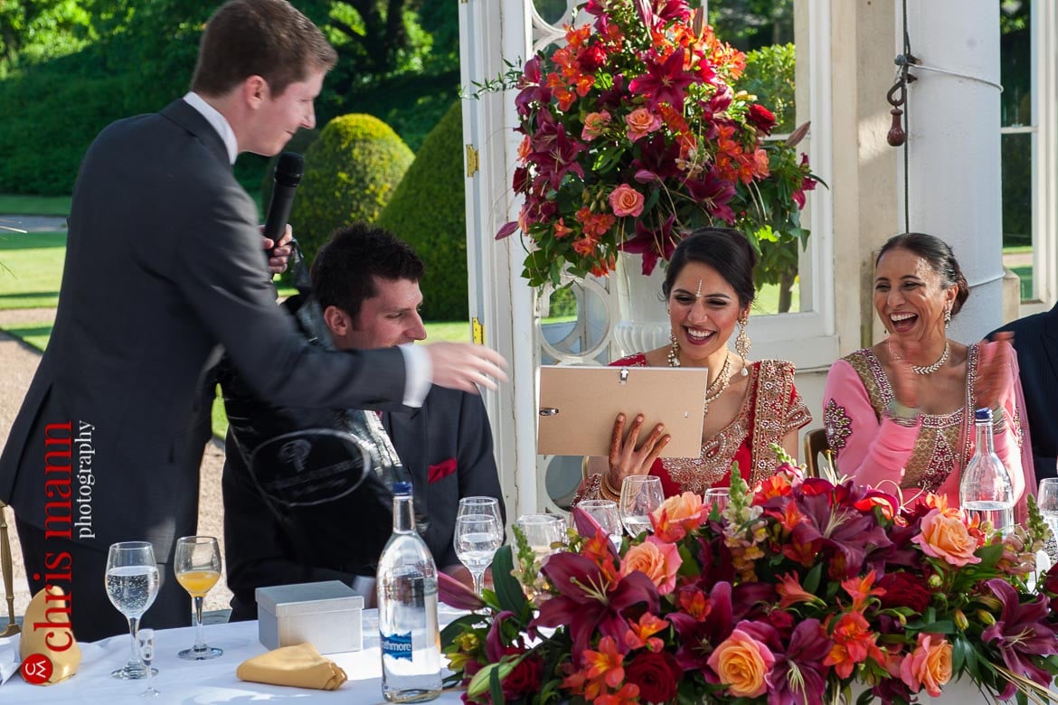 best man presents gift to bride at reception Syon Park Great Conservatory