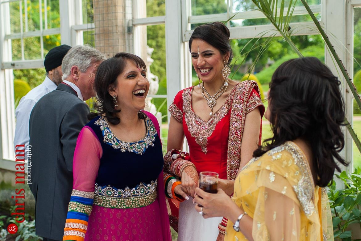 happy bride with relatives at reception Syon Park Great Conservatory