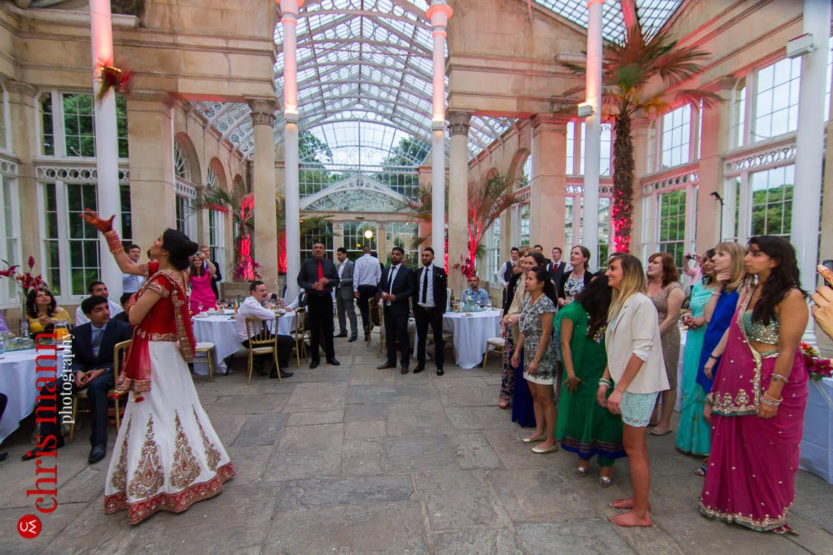 bride tosses bouquet at reception Syon Park Great Conservatory