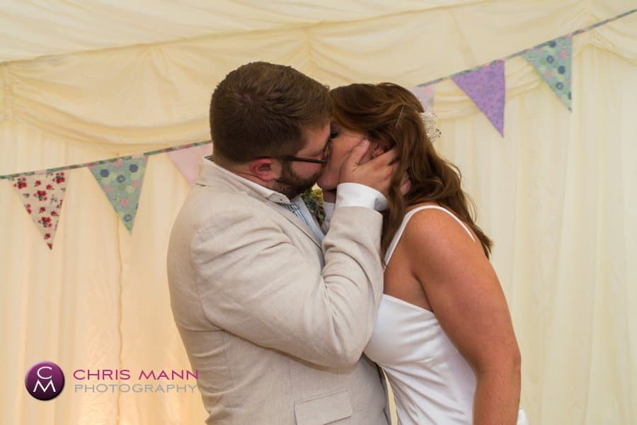 bride and groom kiss wedding reception marquee surrey