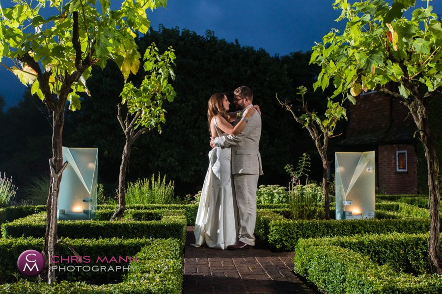 bride and groom among the vines at night