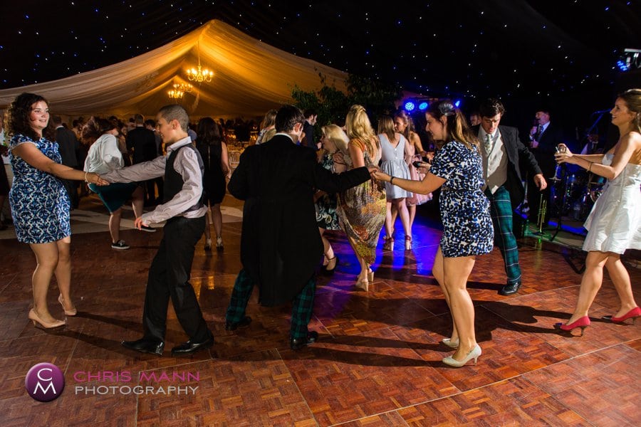 guests dance in the marquee Surrey wedding