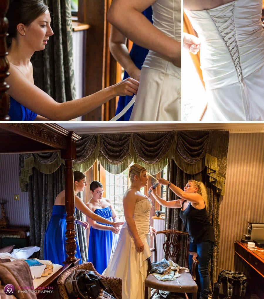 bridesmaids adjust bride's dress before wedding at Langshott Manor