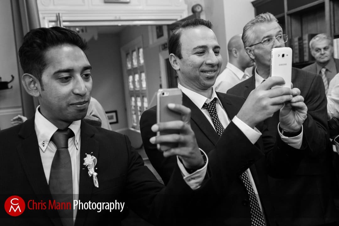 guests photograph the happy couple with their cellphones