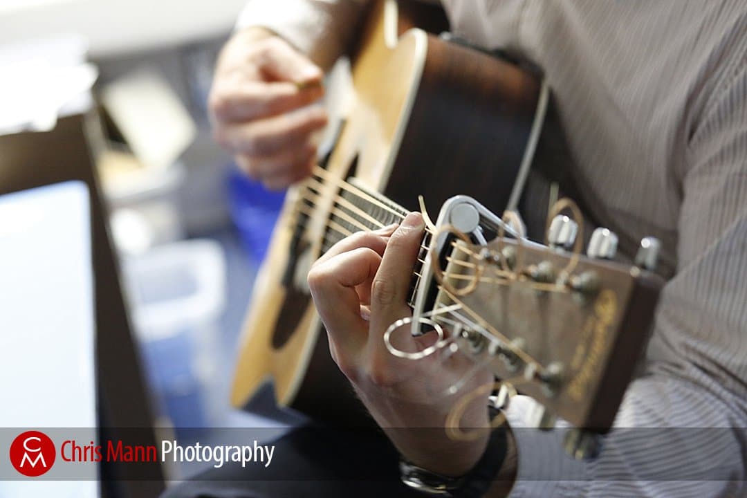 teacher rehearsing song on guitar