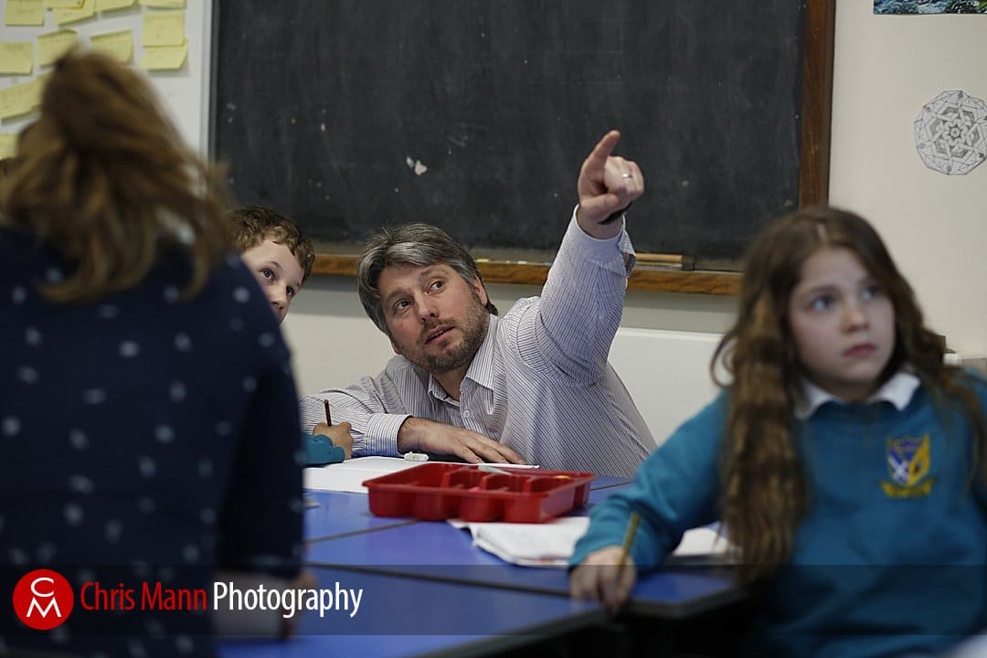 teacher pointing at board