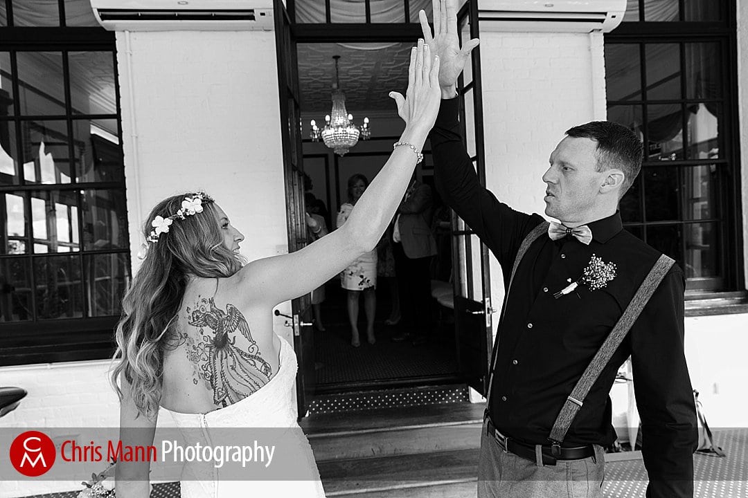 bride and groom high five after wedding ceremony