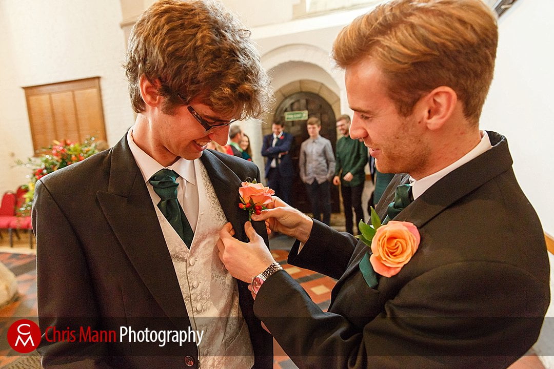 best man pins buttonhole on groom St Ebbe's church Oxford wedding