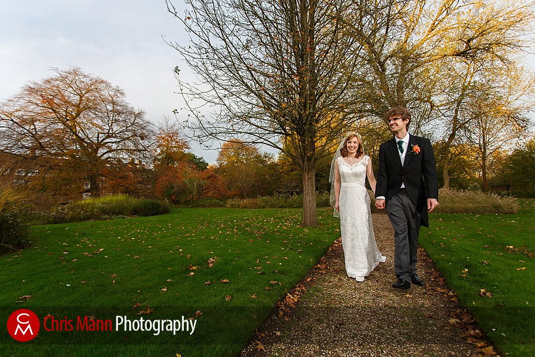 bride and groom walking in gardens Lady Margaret Hall Oxford wedding photos