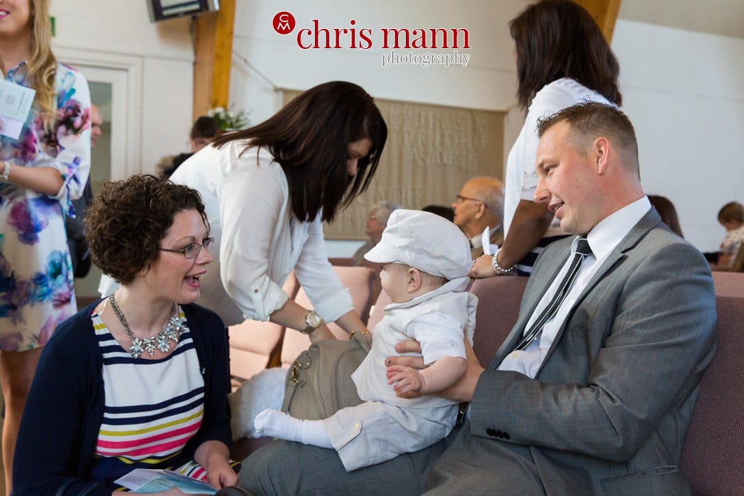 family prepare for christening service