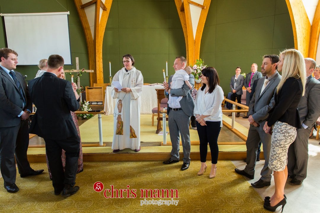 minister leads christening service