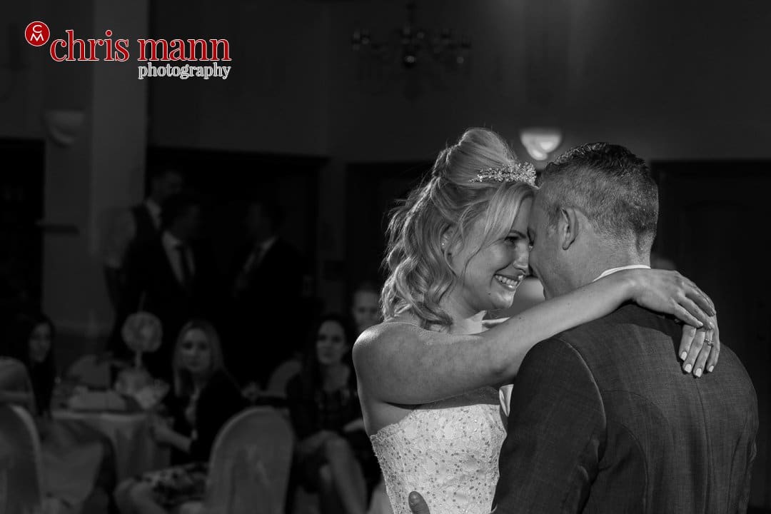 bride and groom first dance Manor House Hotel Guildford black and white photo