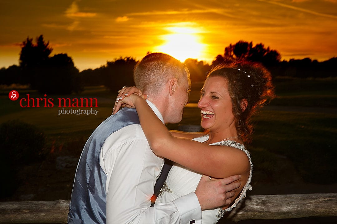 bride and groom hug at sunset surrey downs golf club wedding