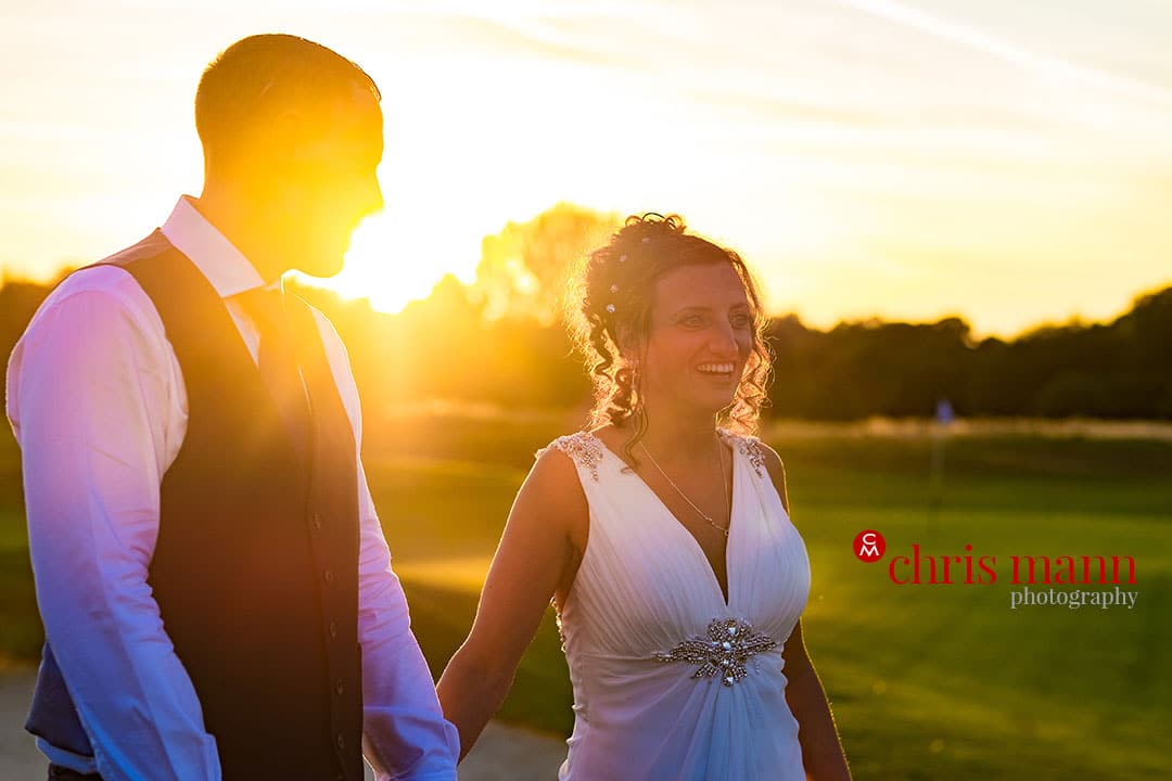 bride and groom walking sunset surrey downs golf club wedding