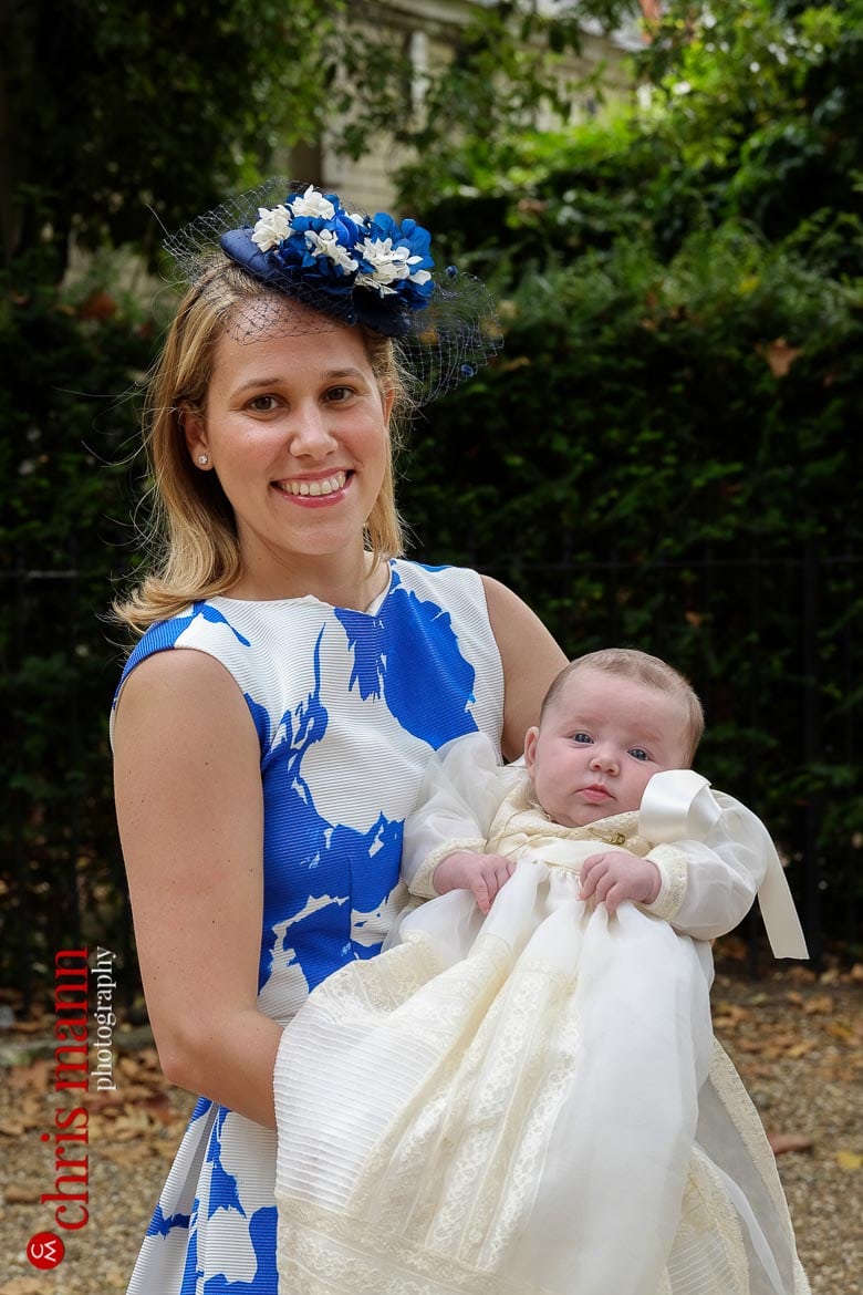 proud mother holdys baby before christening ceremony at Brompton Oratory Knightsbridge London