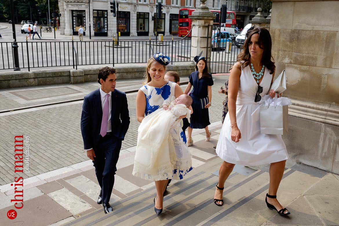 Brompton Oratory christening photos parents and child arrive