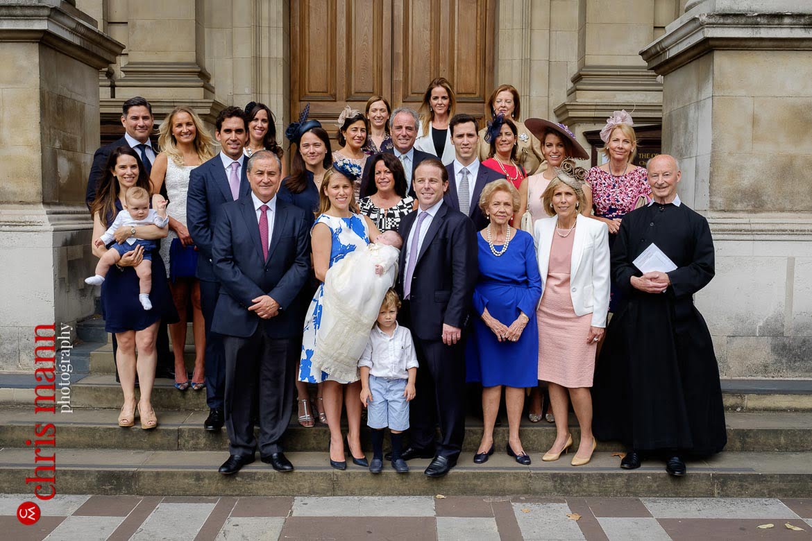 family group photo on steps of Brompton Oratory Knightsbridge London after christening ceremony