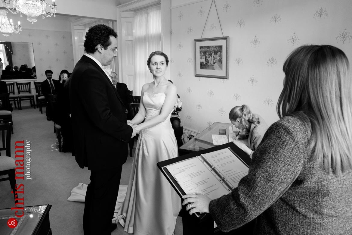 bride and groom holding hands Artington House Guildford register office