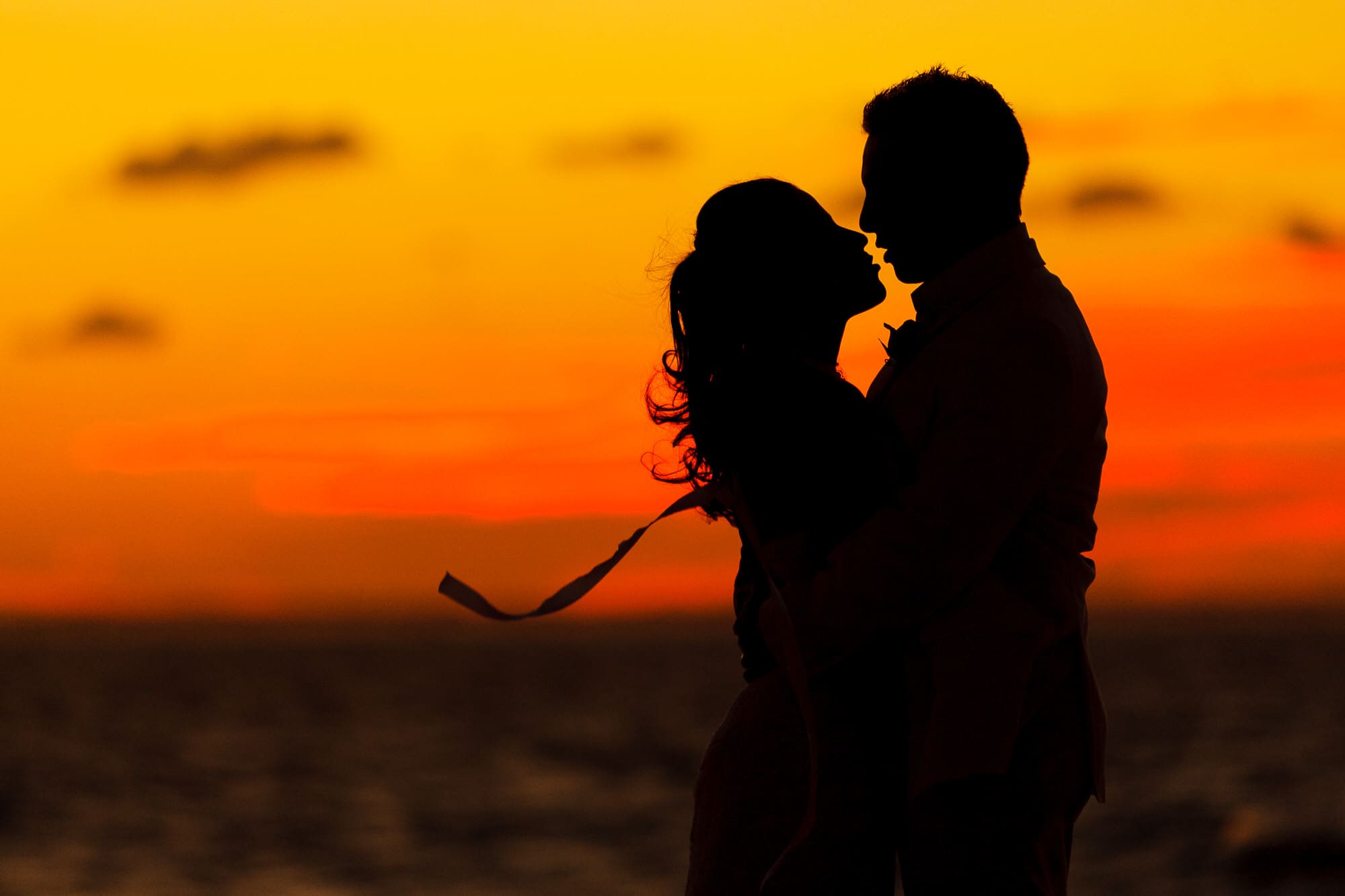 Bride and groom sunset silhouette on Grace Bay beach, Turks & Caicos Islands BWI