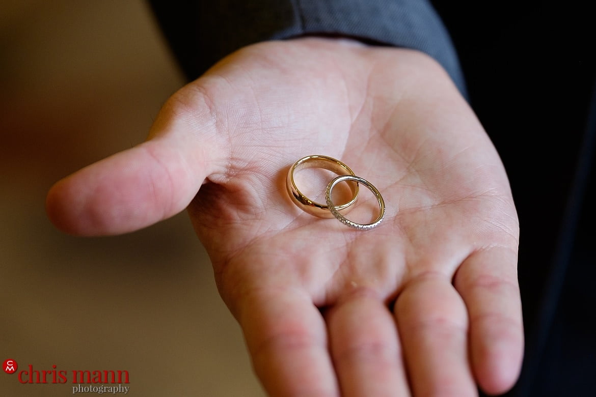 Best Man holds out wedding rings - South Lodge Horsham wedding photography by Chris Mann