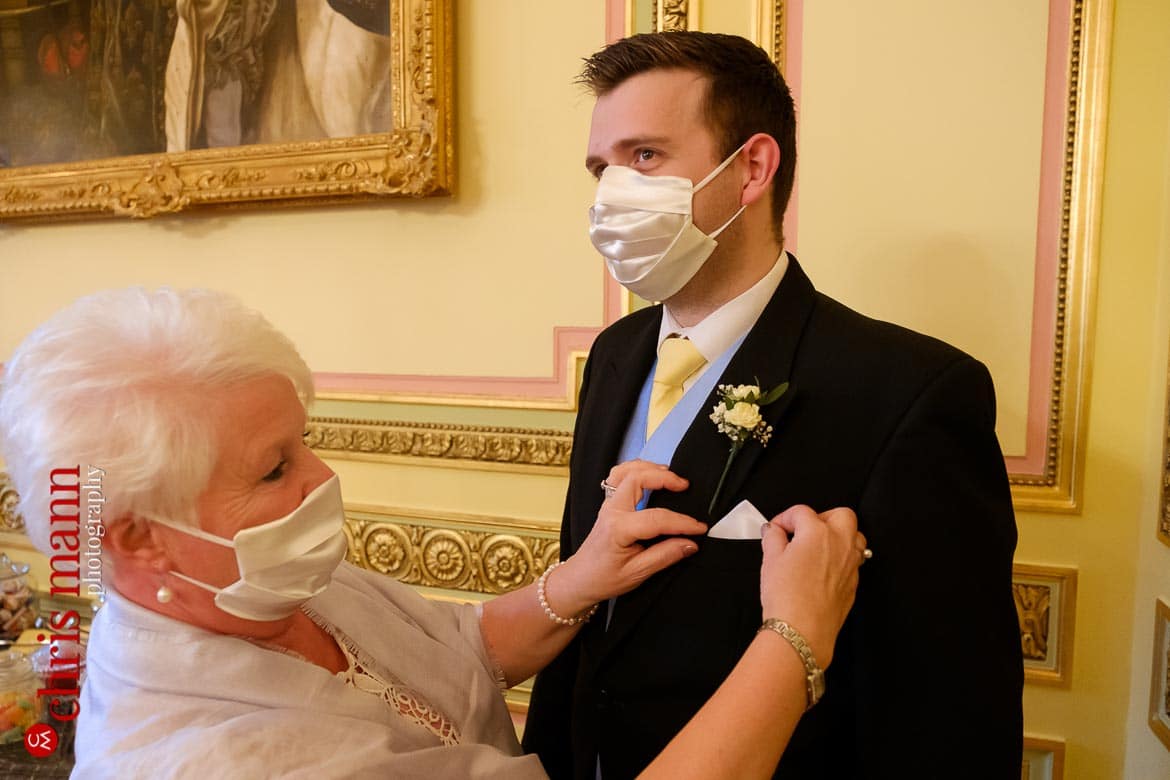 Mask-wearing guests preparing for wedding at the Ritz London