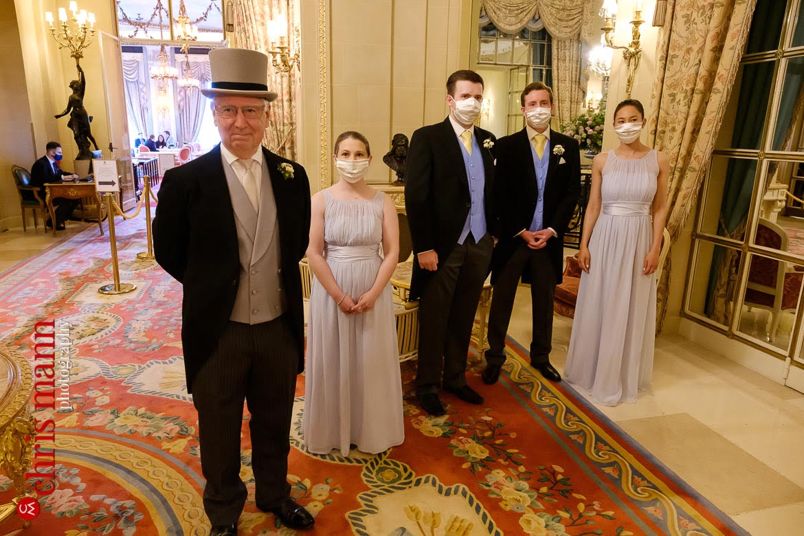 Wedding party waits to greet the bride in the Long Gallery at the Ritz - Ritz London wedding photography
